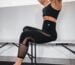 woman in black sports bra and black leggings doing yoga