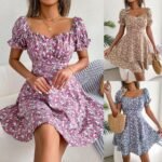 Woman wearing a floral A-line mini dress with puff sleeves and ruffles in a stylish indoor setting.