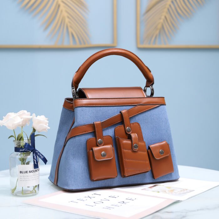 Stylish denim and PU leather handbag with pocket details, suitable for crossbody or handheld