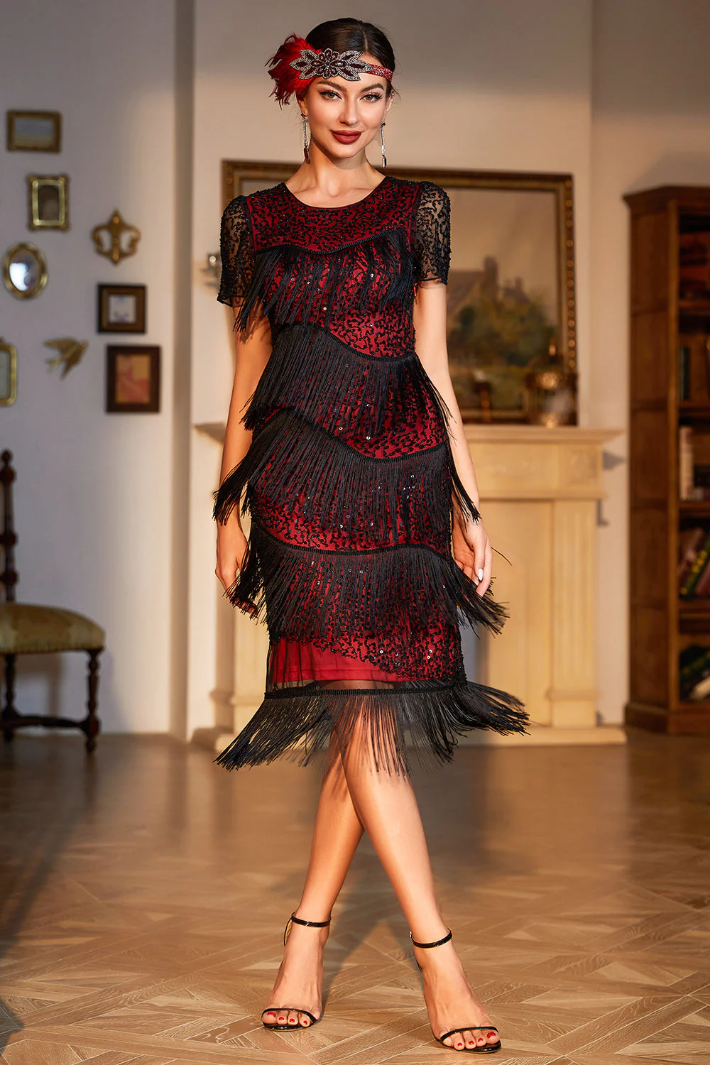 Woman wearing a vintage-inspired fringe and sequin midi dress in black-gold, standing in an elegant setting.