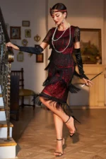 Woman wearing a vintage-inspired fringe and sequin midi dress in black-gold, standing in an elegant setting.