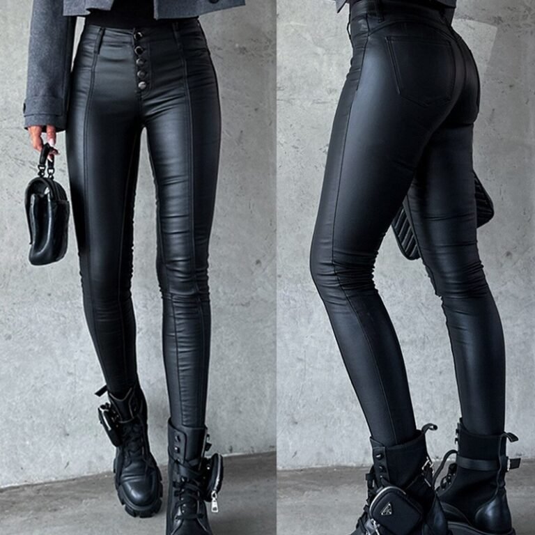 Close-up of black high-waisted faux leather skinny pants with button detail, styled with chunky boots.