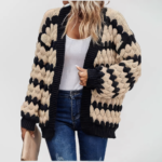 Oversized knit cardigan with textured bubble-knit pattern, styled with casual jeans.