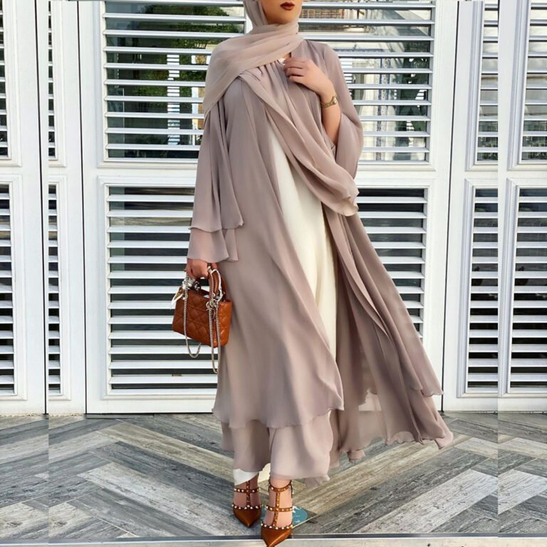 "Elegant black chiffon abaya with layered design, paired with a chic handbag and studded heels."