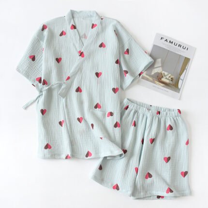 "Pink heart-print cotton lounge set with relaxed top and shorts." "Classic navy blue cotton lounge set with wrap-style top and elastic shorts."