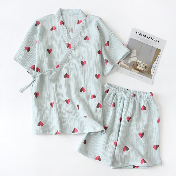 "Pink heart-print cotton lounge set with relaxed top and shorts." "Classic navy blue cotton lounge set with wrap-style top and elastic shorts."