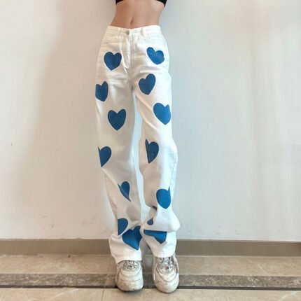 "Heart print wide-leg jeans in white denim with blue heart accents."