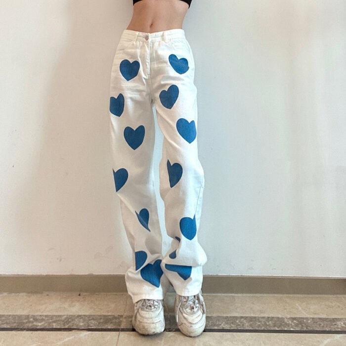 "Heart print wide-leg jeans in white denim with blue heart accents."