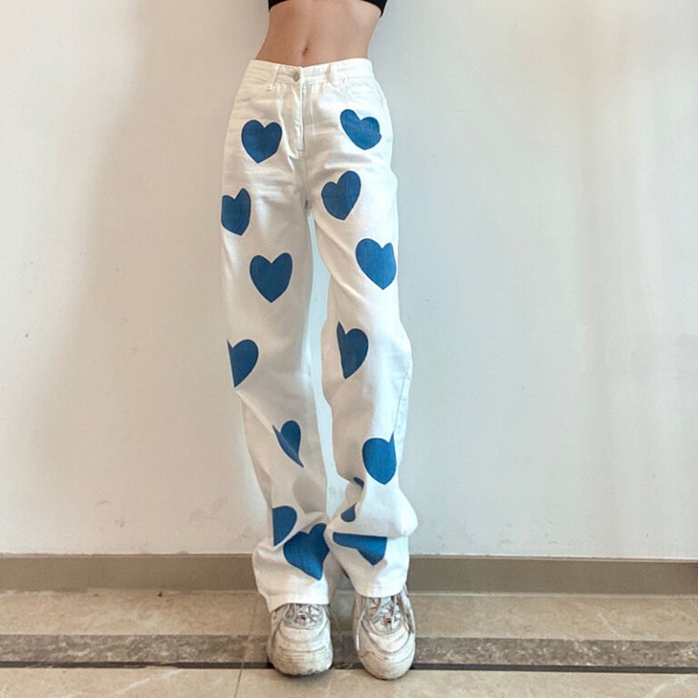 "Heart print wide-leg jeans in white denim with blue heart accents."