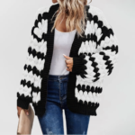 Oversized knit cardigan with textured bubble-knit pattern, styled with casual jeans.