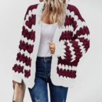 Oversized knit cardigan with textured bubble-knit pattern, styled with casual jeans.