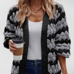 Oversized knit cardigan with textured bubble-knit pattern, styled with casual jeans.