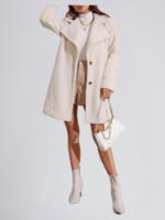 Model wearing an off-white teddy wool coat with a button-front design and wide lapels, styled with a turtleneck and boots.