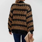 Oversized knit cardigan with textured bubble-knit pattern, styled with casual jeans. brown-with-black