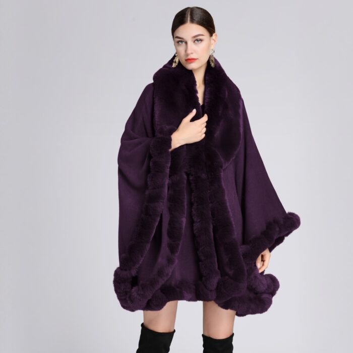 Woman wearing a luxurious imitation cashmere batwing cardigan with fur trim in dark blue.