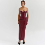 Bordeaux faux-leather bustier midi dress with sweetheart neckline and side slit, styled in a luxurious library setting