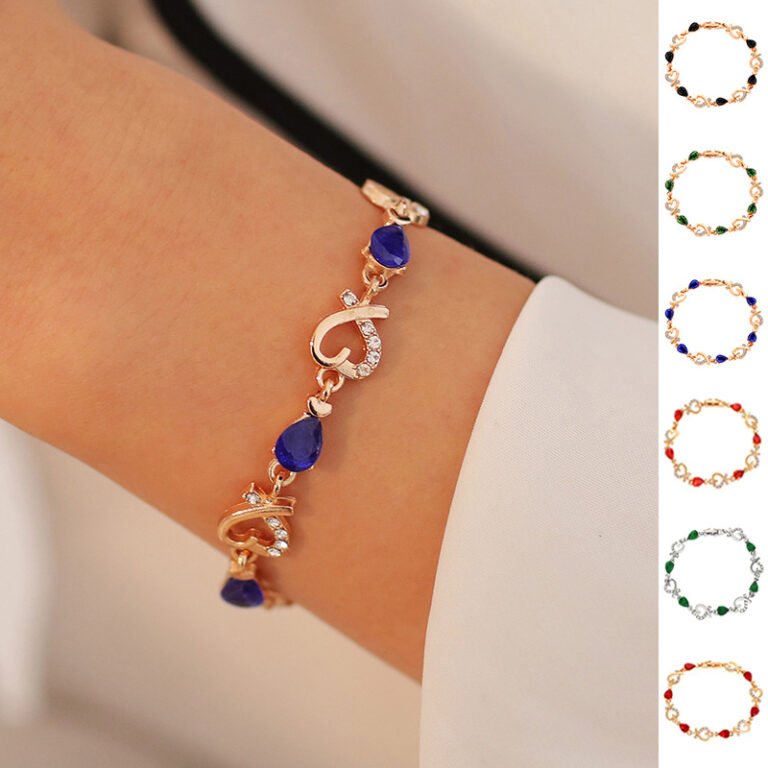 Close-up of the Heartstone Elegance Bracelet in gold with red gemstones, exuding sophistication.