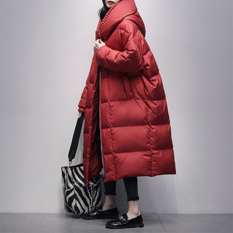 Oversized hooded longline puffer coat in black, cream, and red, with quilted design and cozy hood, perfect for cold weather styling.