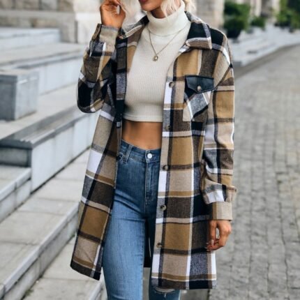 Oversized plaid flannel shacket in neutral tones, styled with jeans and boots for a cozy fall look.