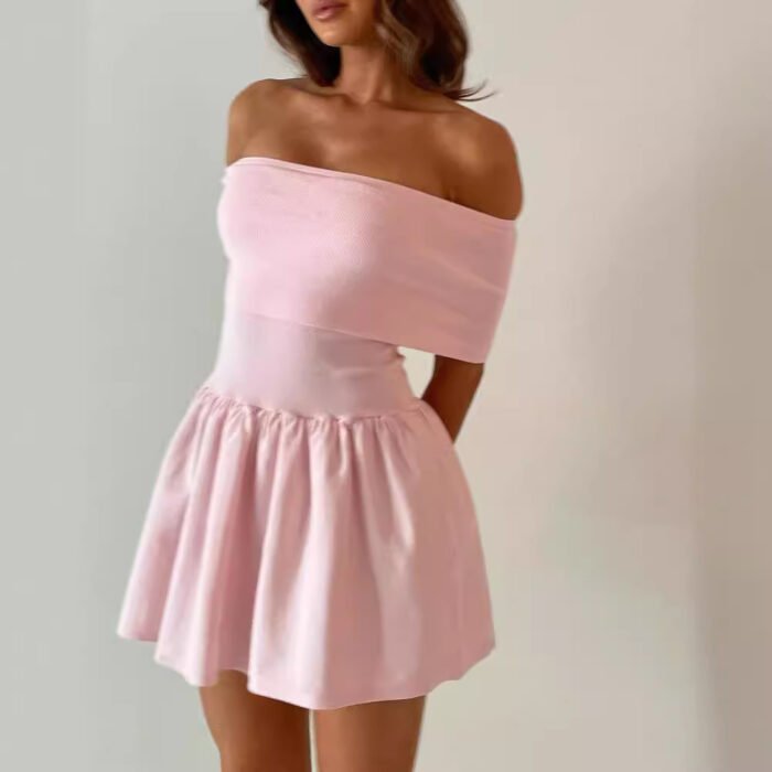 Woman wearing an off-shoulder mini dress in white/pink, styled elegantly.