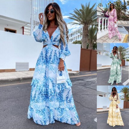 Model wearing a flowing floral print cutout maxi dress with sheer long sleeves in pink, blue, green, and yellow.