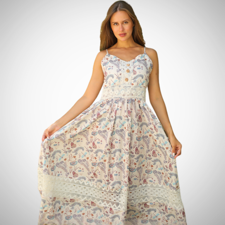 Model wearing a lace-trimmed floral maxi dress with spaghetti straps, buttoned bodice, and a flowy silhouette in a garden setting.