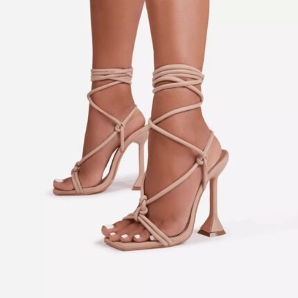 Strappy lace-up high heels with a geometric stiletto heel and square toe in black, nude, and pink.