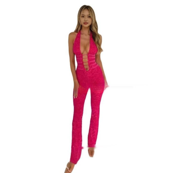 Woman wearing black cutout plunge halter jumpsuit in studio
