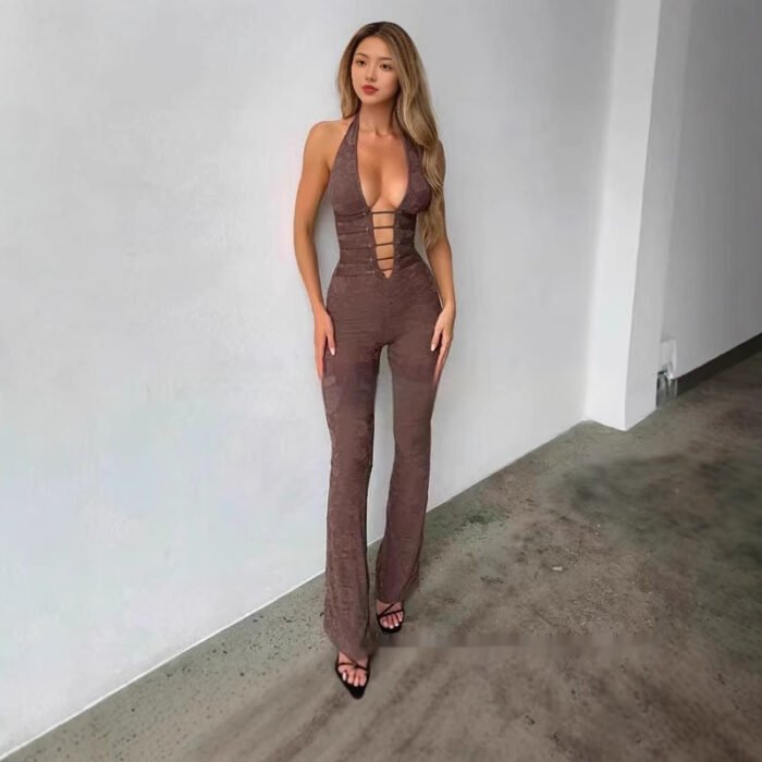 Woman wearing black cutout plunge halter jumpsuit in studio