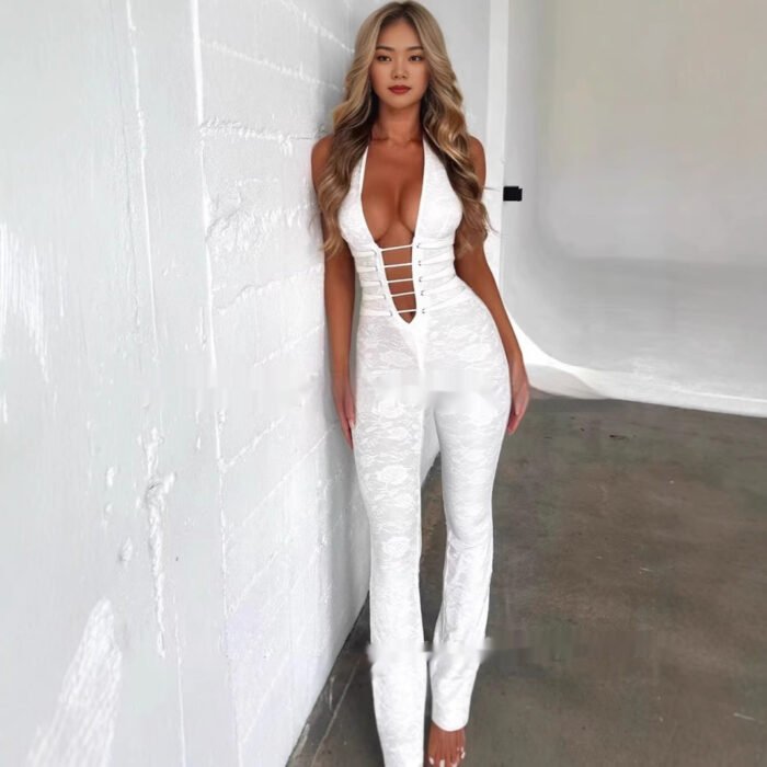 Woman wearing black cutout plunge halter jumpsuit in studio