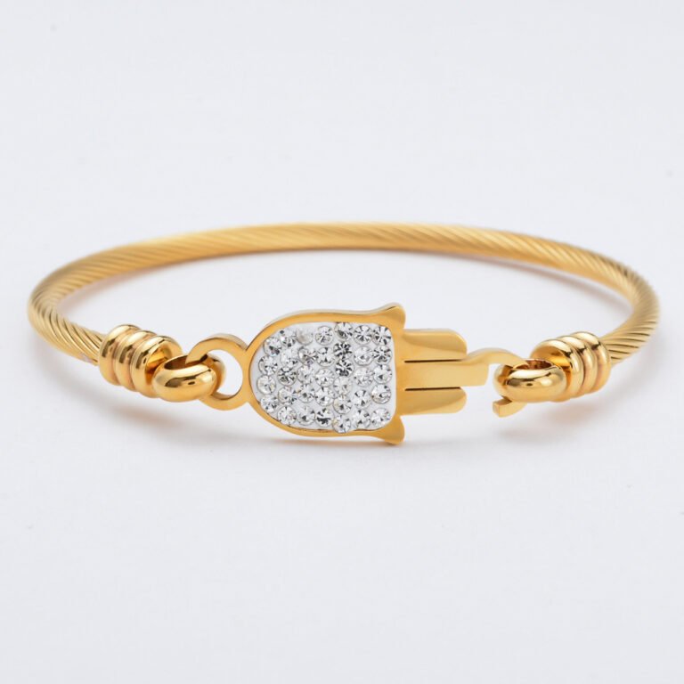 Gold cable bracelet with treble clef and rhinestones Gold bracelet featuring hamsa hand with rhinestone inlay Plain gold bracelet with heart center design Heartbeat gold bracelet with crystal accent