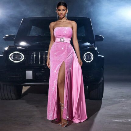 Model in pink strapless sequin gown standing in front of black SUV