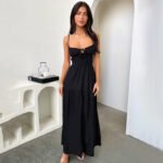 Model wearing black tiered maxi dress with tie-front bust and spaghetti straps; Model in white maxi dress with sweetheart neckline; Lilac and beige maxi dresses with flowing tiered skirt.