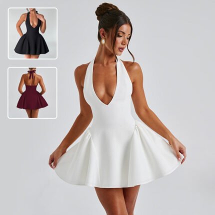 Woman in white deep V halter flare mini dress posing confidently