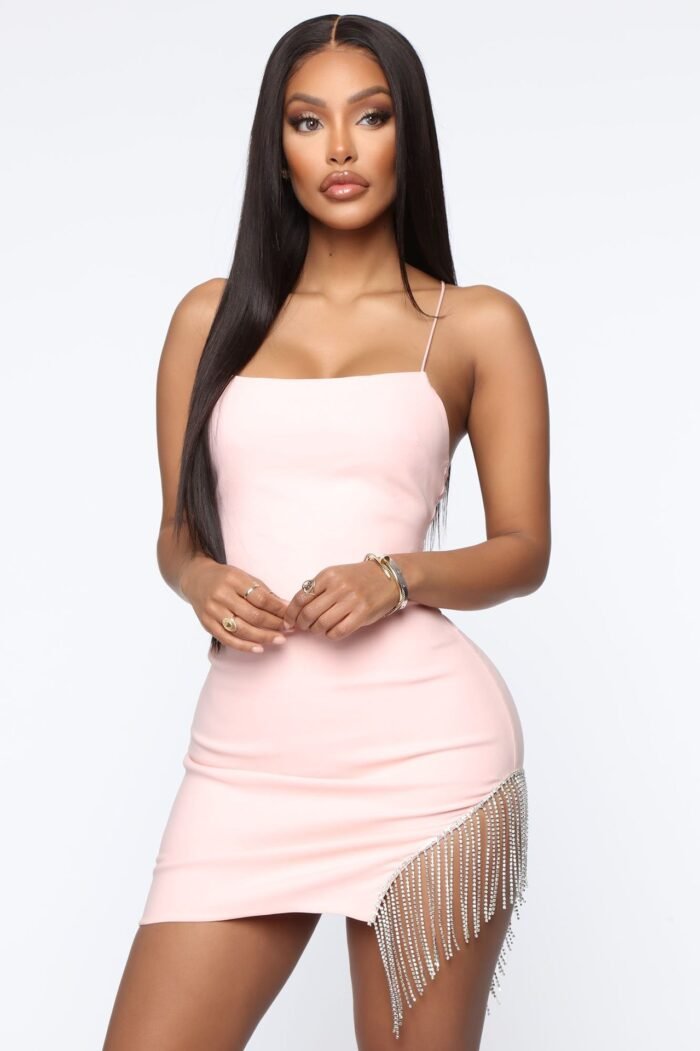 Woman in black rhinestone slit bodycon mini dress Back view of blush pink rhinestone slit dress Front view of red slit sparkle mini dress White sparkle mini dress with side rhinestone detail
