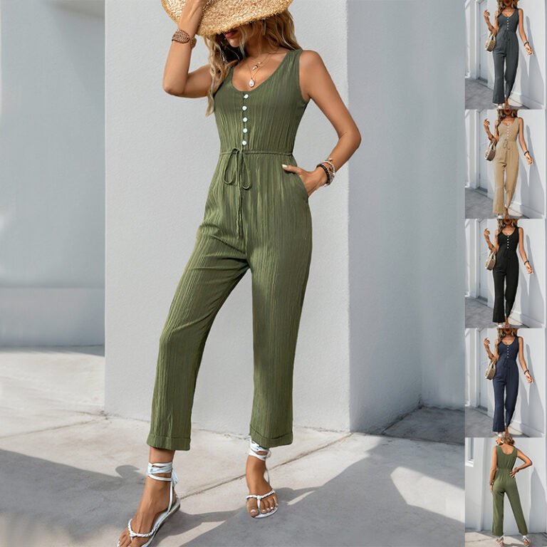 Woman wearing olive sleeveless cropped jumpsuit with back view Woman wearing beige cropped sleeveless jumpsuit holding a woven bag Woman in black utility jumpsuit styled with strappy sandals