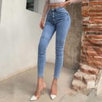 alt="Butt-lifting skinny jeans with triple-button waist"