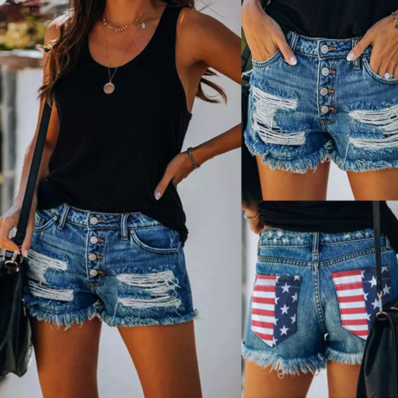 Woman wearing distressed denim shorts with American flag patches