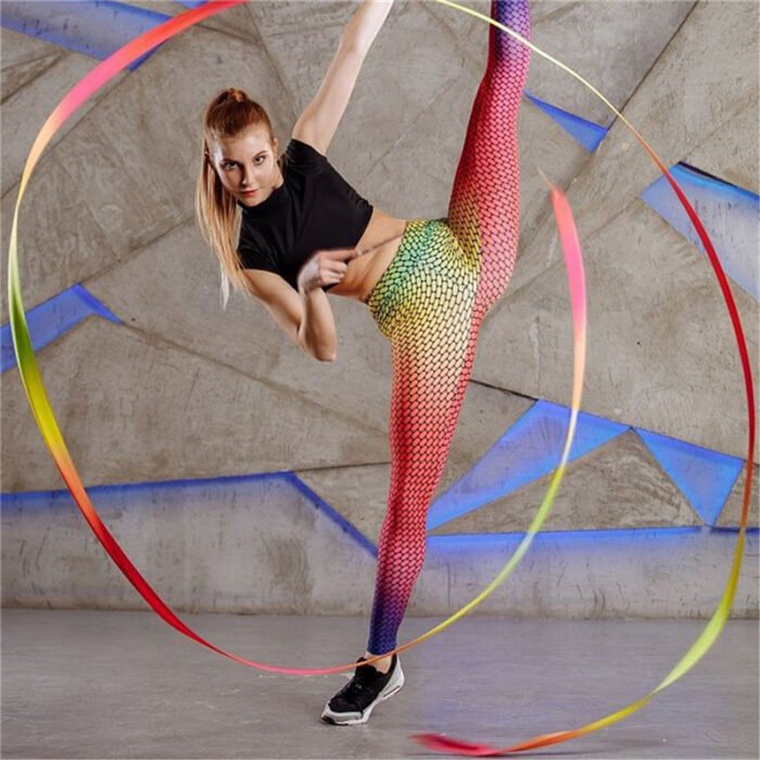 Model wearing high-waisted gradient mesh print leggings in pink, yellow, and blue ombré effect