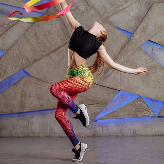 Model wearing high-waisted gradient mesh print leggings in pink, yellow, and blue ombré effect