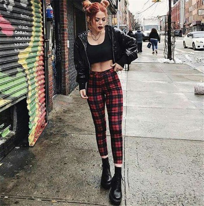 Models wearing plaid high-waisted pants in black and white checkered, red plaid, and yellow tartan prints, paired with white sneakers.