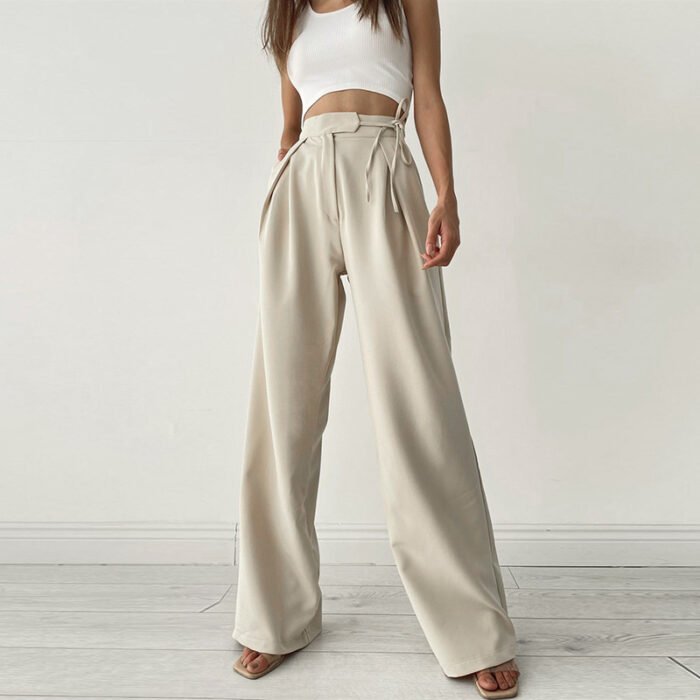 Woman wearing cream satin high waist wide-leg trousers with side ties
