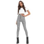 Models wearing plaid high-waisted pants in black and white checkered, red plaid, and yellow tartan prints, paired with white sneakers.
