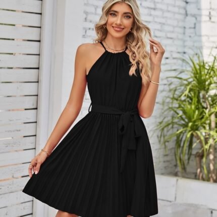 Model in black halter dress with pleated skirt