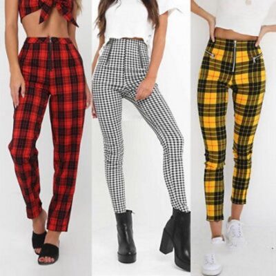 Models wearing plaid high-waisted pants in black and white checkered, red plaid, and yellow tartan prints, paired with white sneakers.