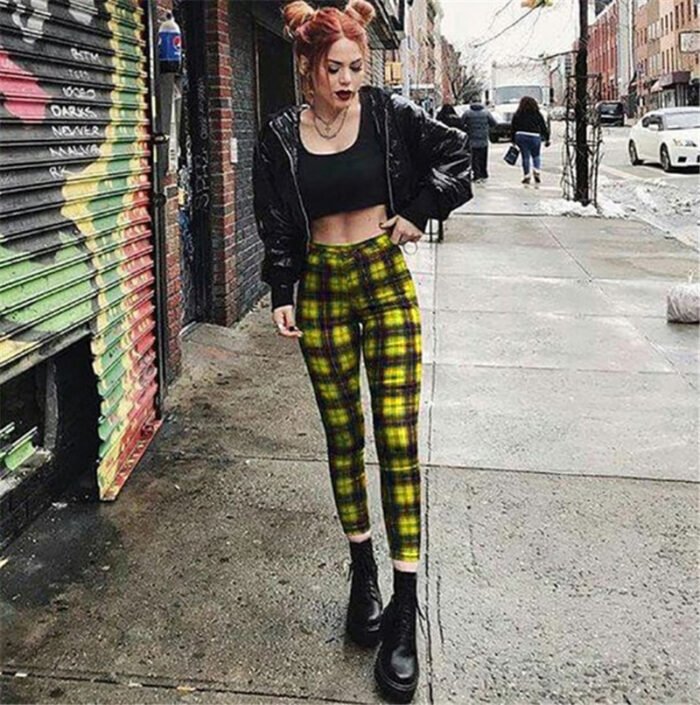 Models wearing plaid high-waisted pants in black and white checkered, red plaid, and yellow tartan prints, paired with white sneakers.