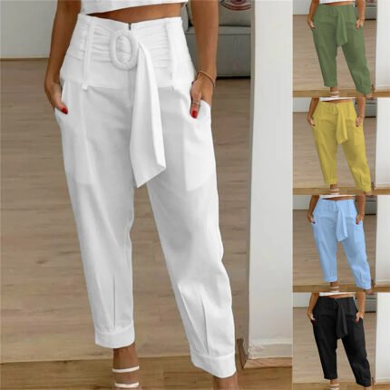 Woman wearing white belted pleated pants