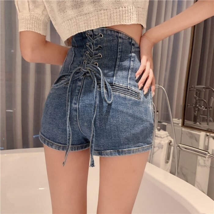 Back view of woman wearing high-waisted denim shorts with lace-up corset detailing.