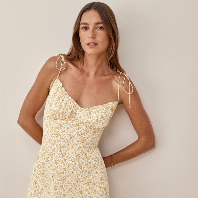 Woman wearing yellow floral tie-strap midi dress with ruched neckline