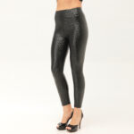 Woman wearing high-waisted black faux leather leggings with embossed leopard print, paired with heels. Rear and front views shown.